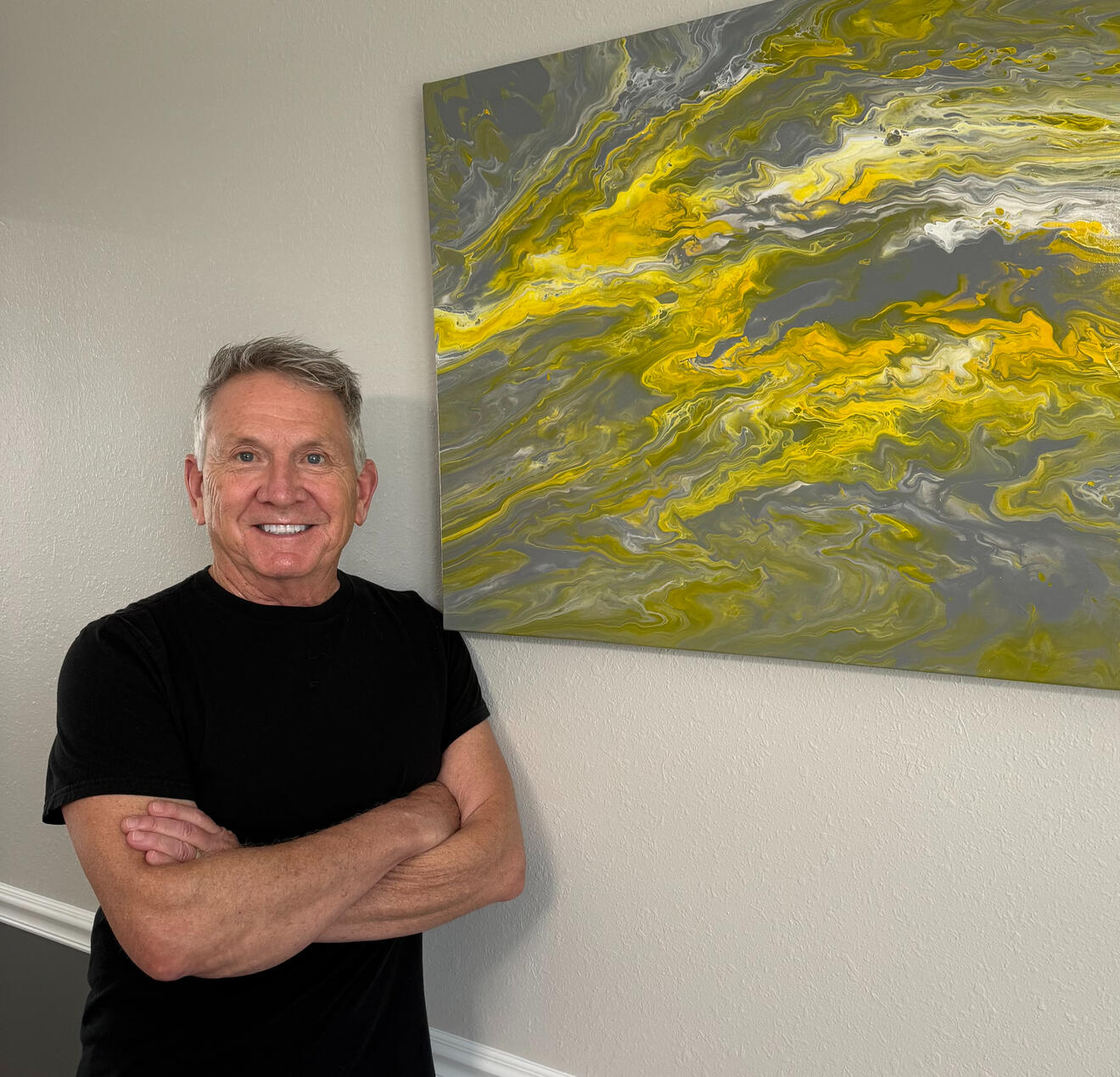 Terry Johnson posing with one of his paintings